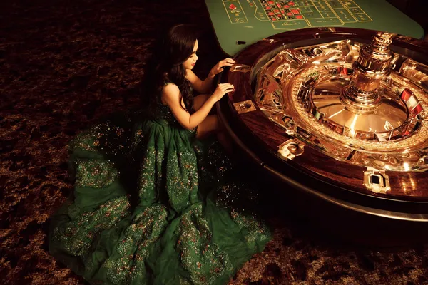JLWILD Casino — Step inside our high-end casino experience A glamorous woman holding casino chips in a neon-lit environment, representing the premium online casino atmosphere of JLWILD.