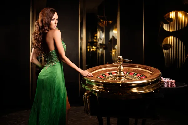 JLWILD Member Login — Return to your personalized dashboard A person using their device against a moody casino-themed background, illustrating the smooth re-entry process at JLWILD.
